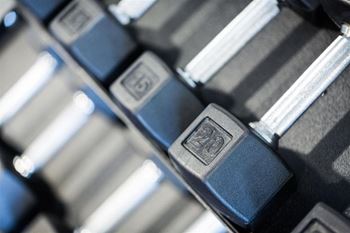 A close up of a set of dumbbells with the number 25 visible on one of them.